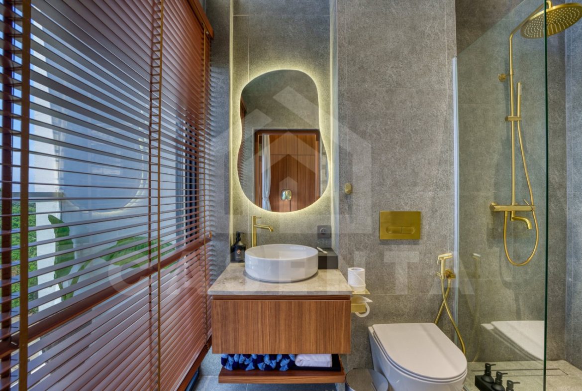 Stylish bathroom with gold fixtures in Pandawa villa
