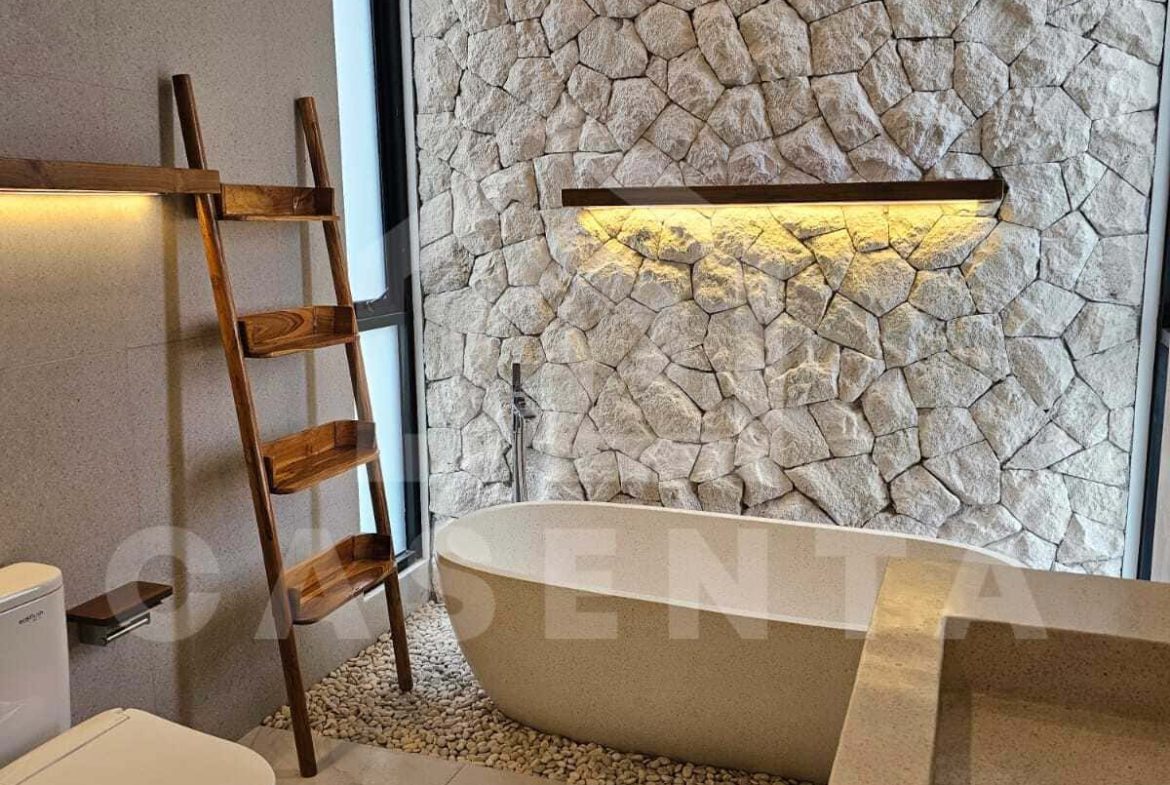 Modern bathroom with freestanding bathtub in cemagi villa