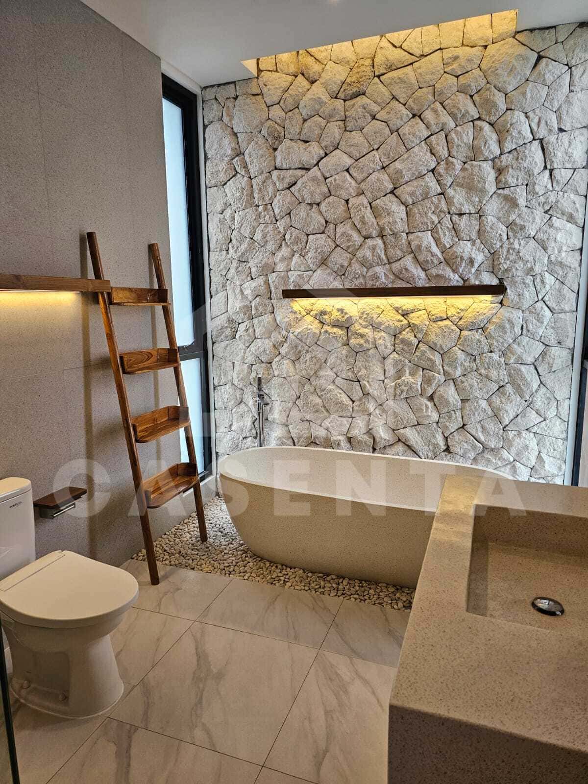 Modern bathroom with freestanding bathtub in cemagi villa