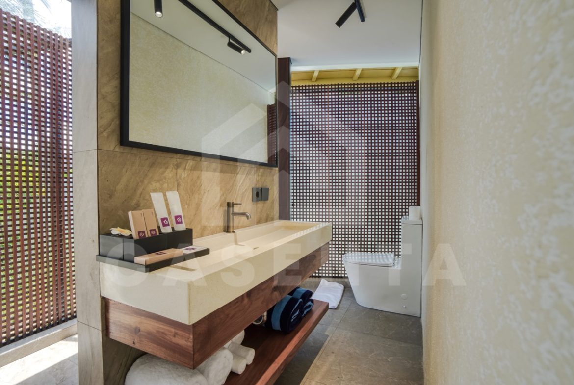ensuite bathroom in Ubud villa with stone vanity and natural light