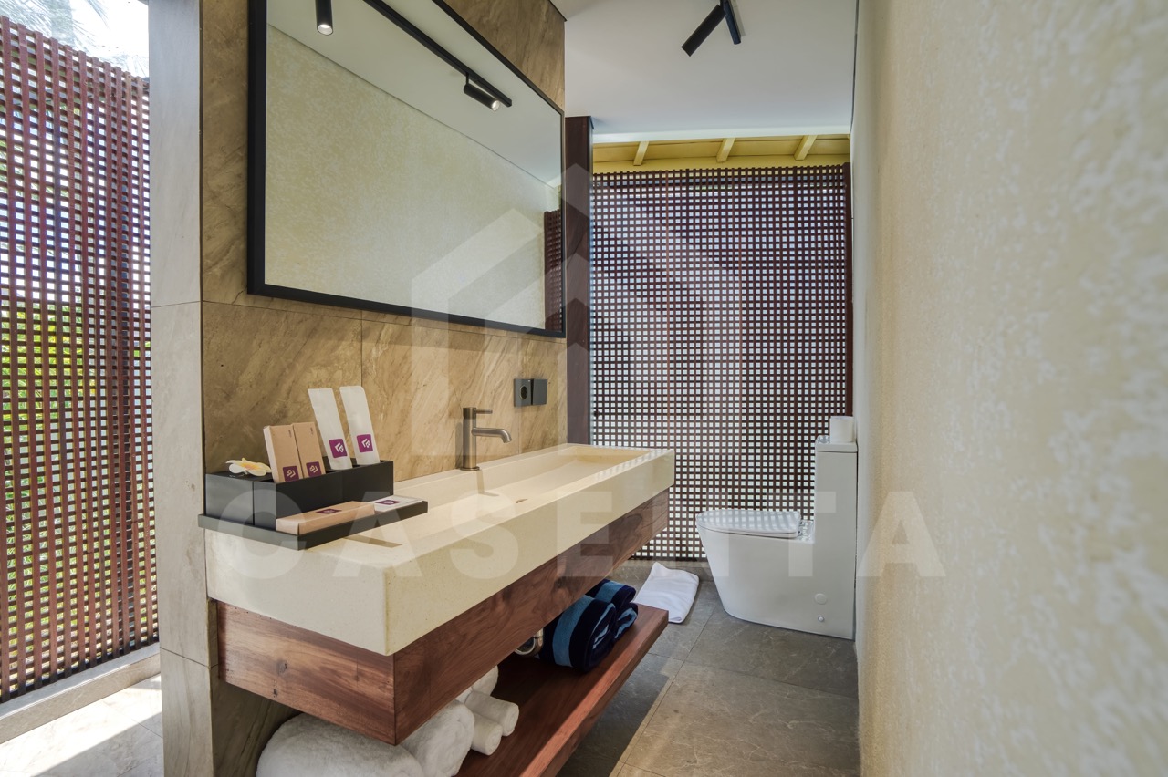 ensuite bathroom in Ubud villa with stone vanity and natural light
