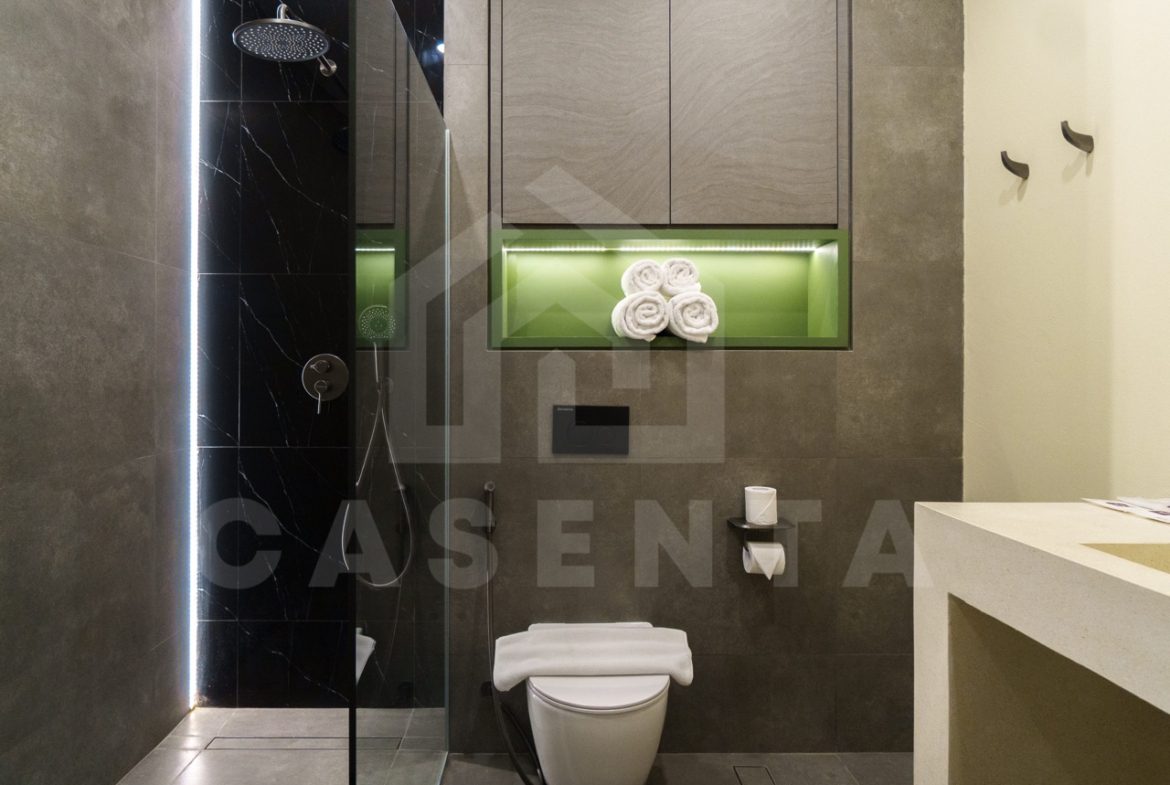 Contemporary bathroom in Canggu apartment with rainfall shower and modern finishes