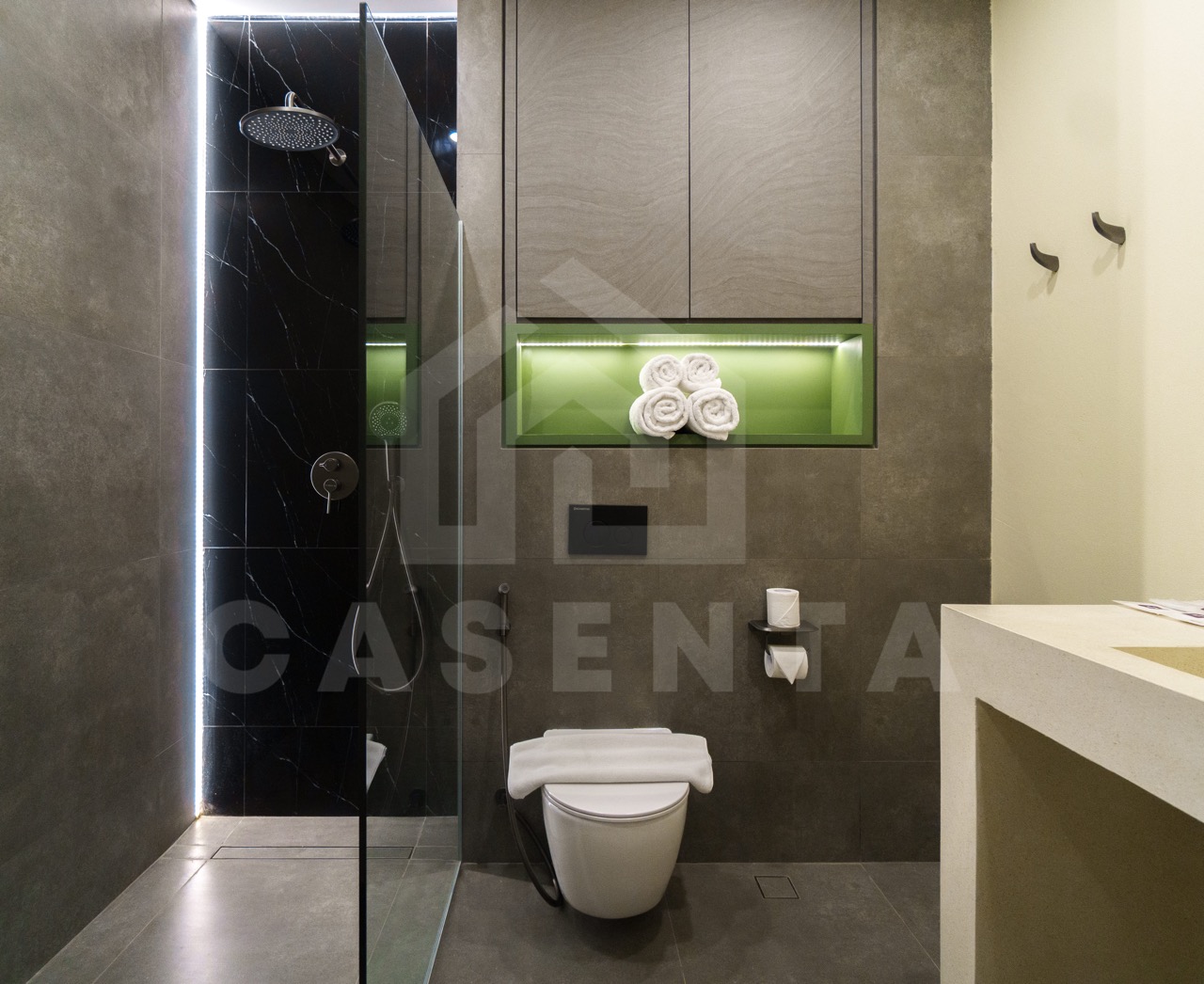 Contemporary bathroom in Canggu apartment with rainfall shower and modern finishes