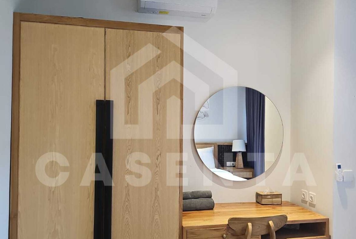 Stylish bedroom with workspace in modern Canggu villa