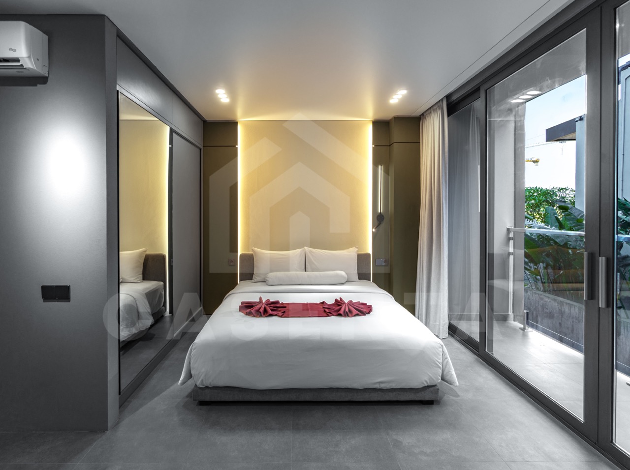 Minimalist bedroom in Canggu apartment with warm lighting and modern design
