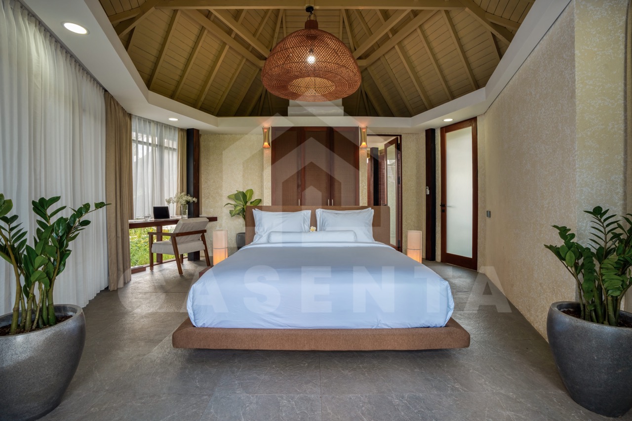 spacious bedroom in Ubud villa with high ceiling and tropical design