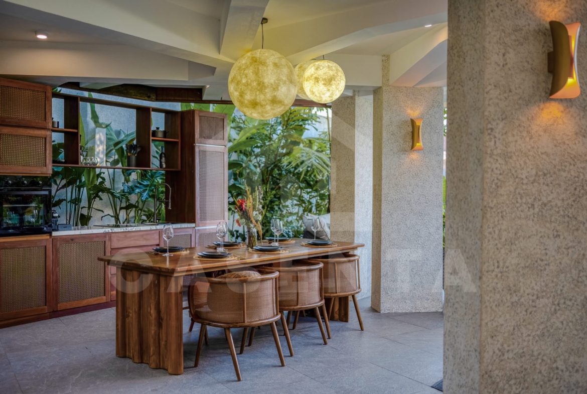 open dining area tropical Ubud villa with wood finishes and garden view