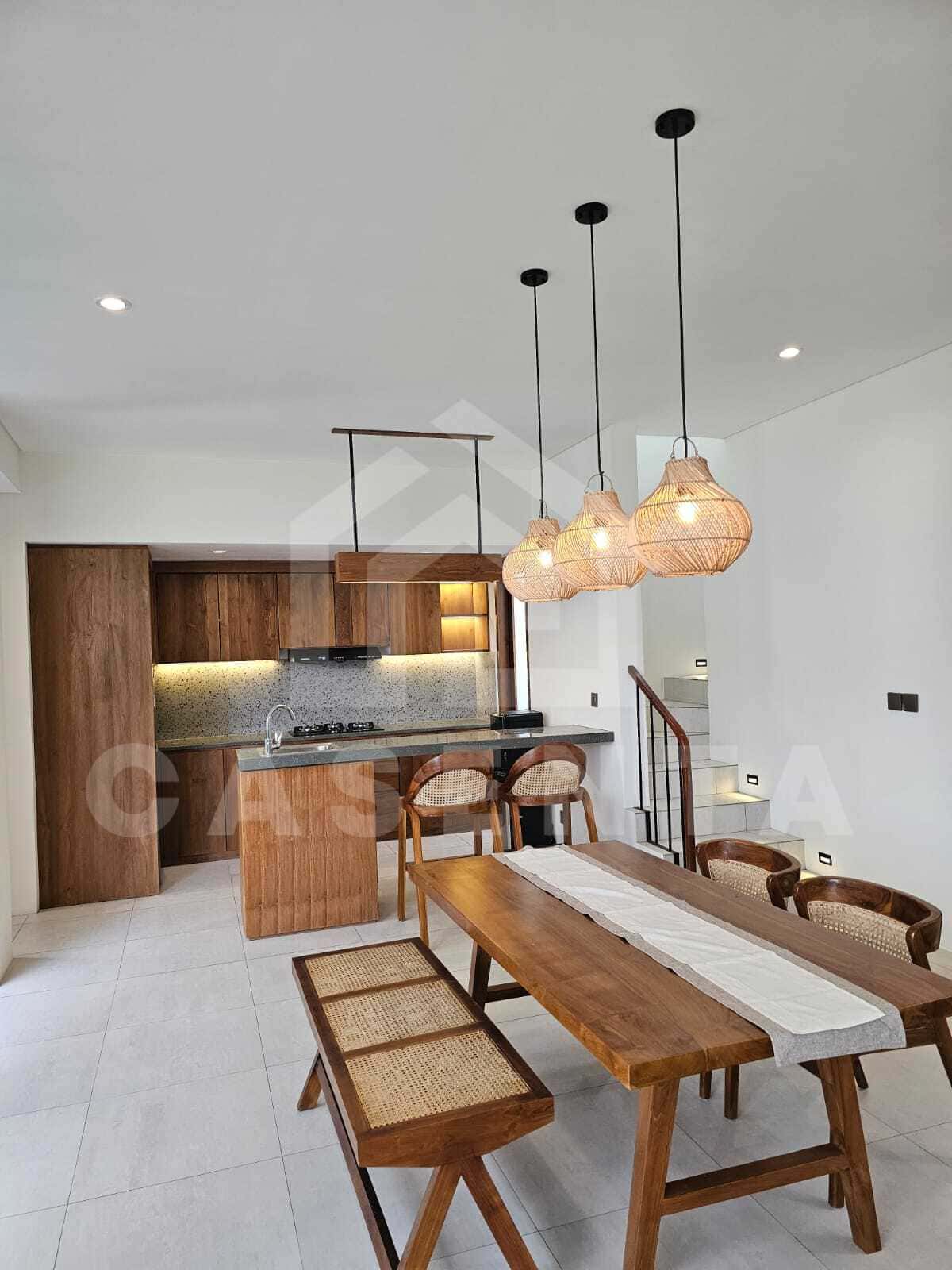 Open dining and kitchen area in modern cemagi villa