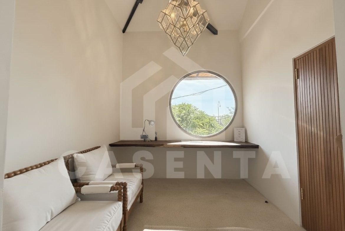 Dedicated indoor workspace with round window in villa