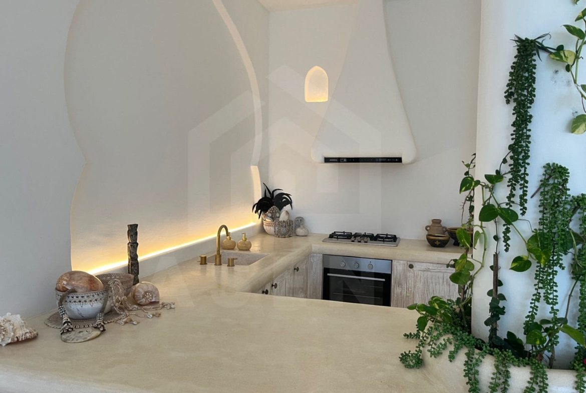 Fully equipped kitchen with curved island in stylish seseh villa