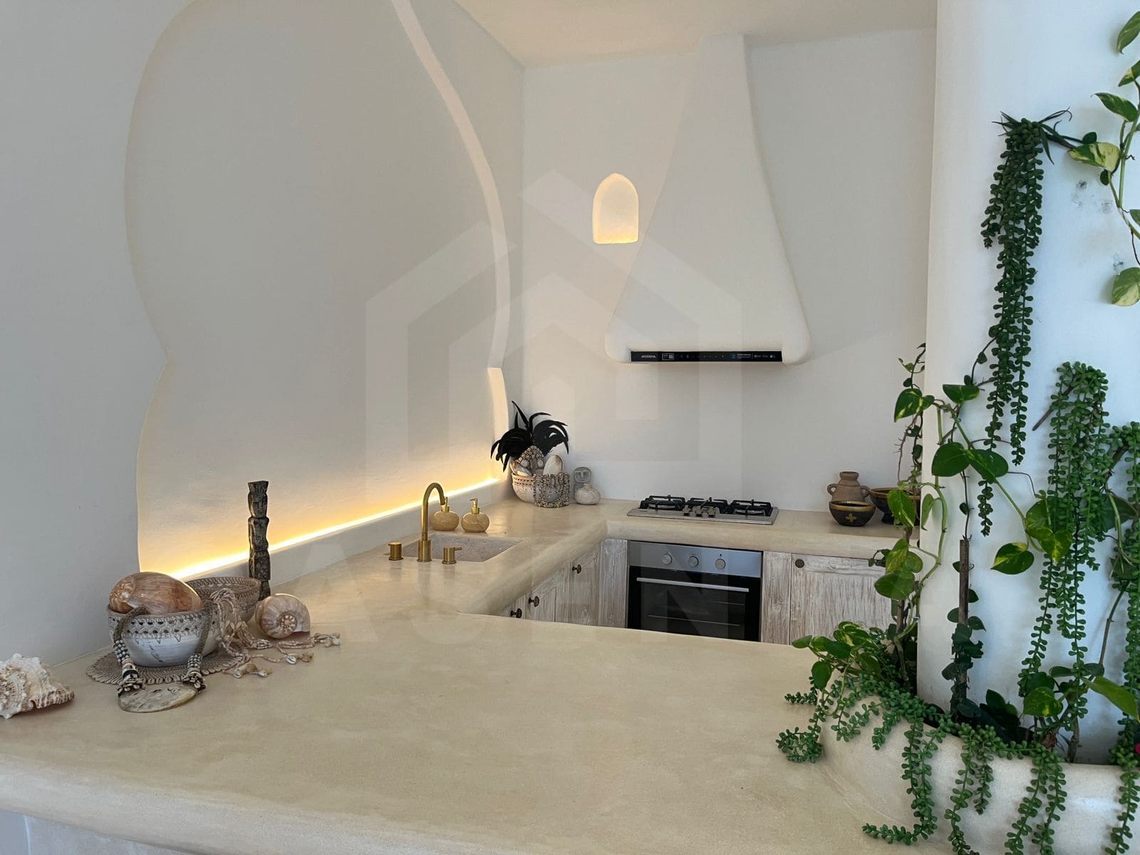 Fully equipped kitchen with curved island in stylish seseh villa