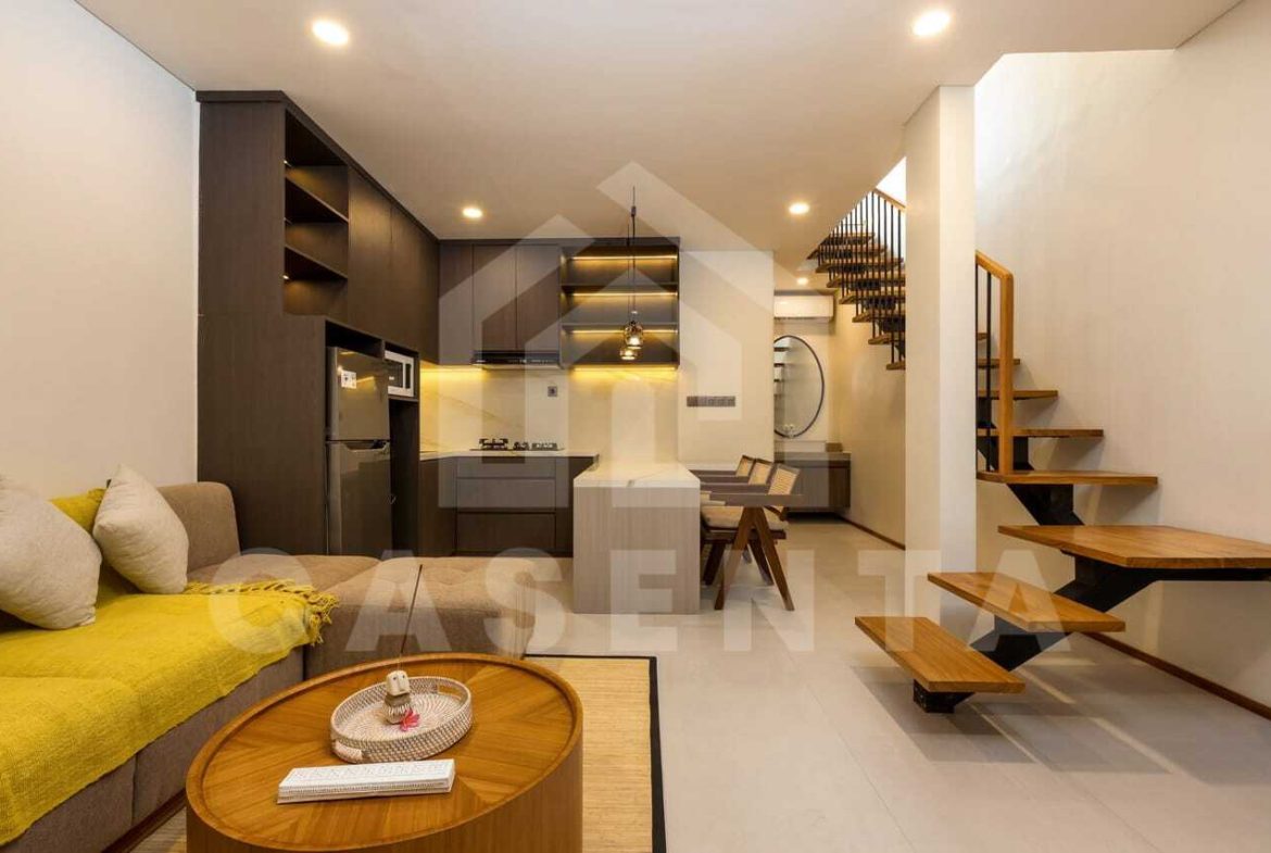 Open living and dining area with kitchen island in saba beach villa