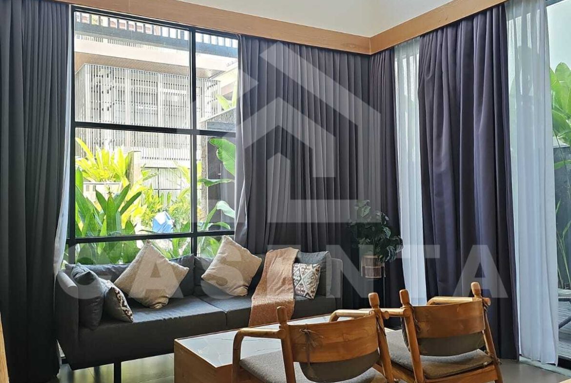 High ceiling living area in Canggu villa with large windows