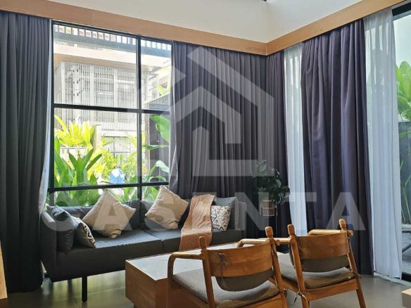 High ceiling living area in Canggu villa with large windows