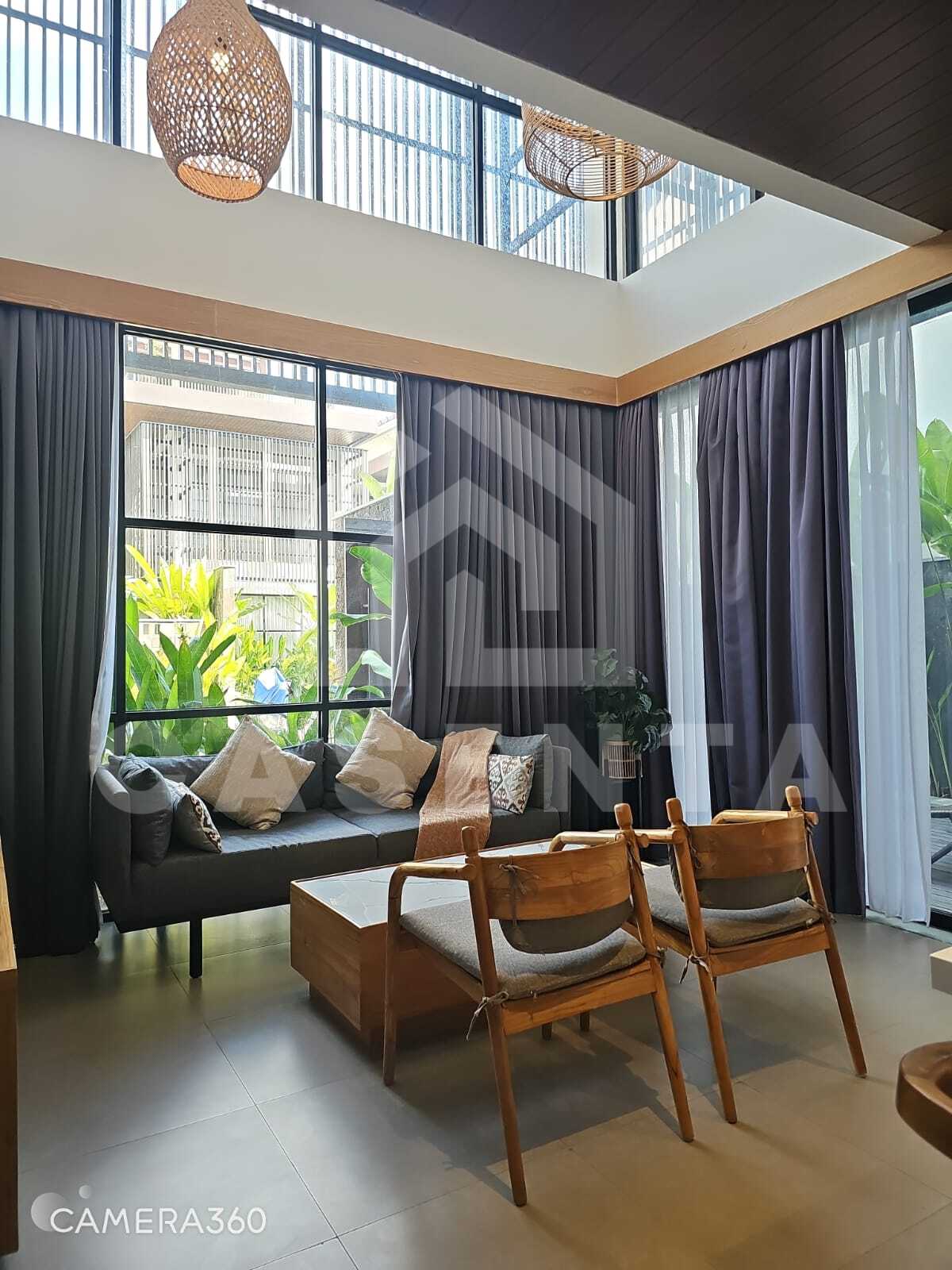 High ceiling living area in Canggu villa with large windows