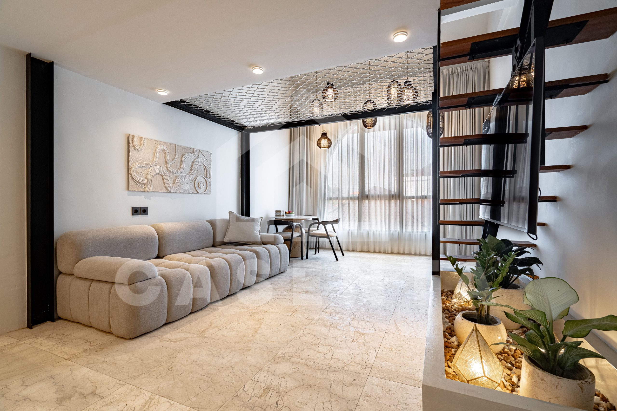 Open living space with mezzanine loft in Sanur apartment