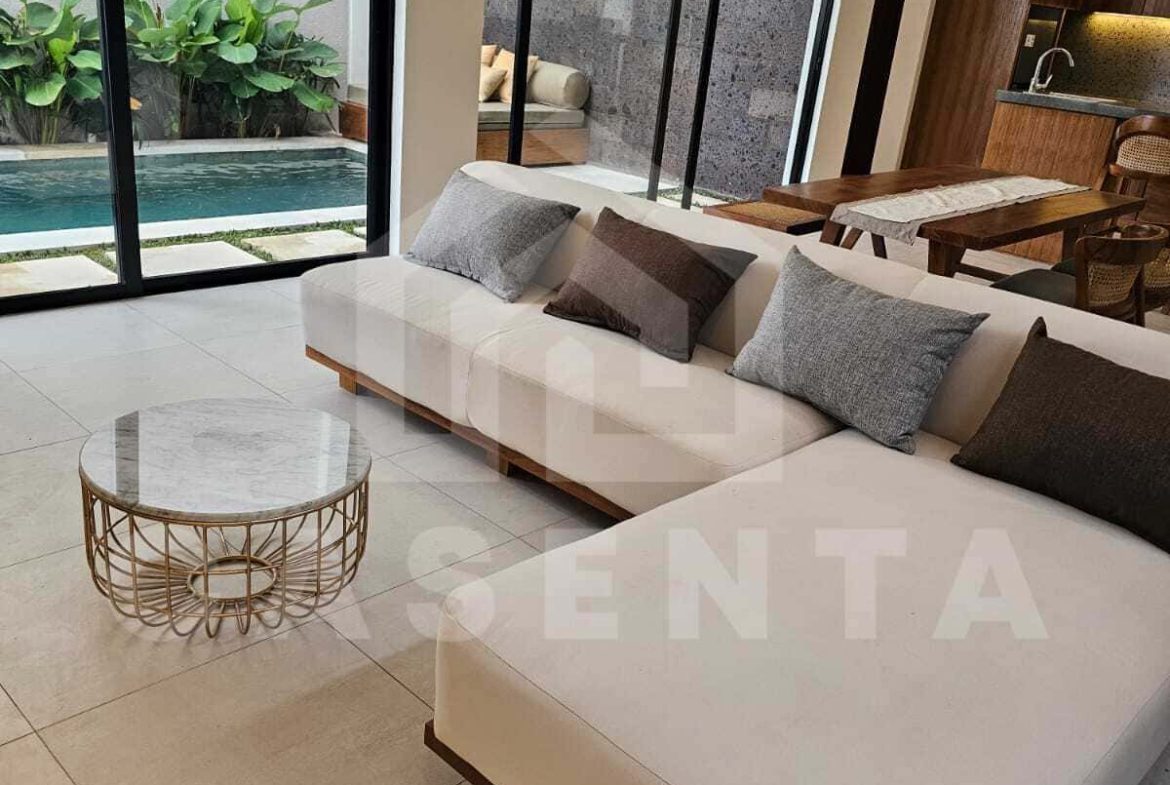 Enclosed living room with pool view in cemagi villa