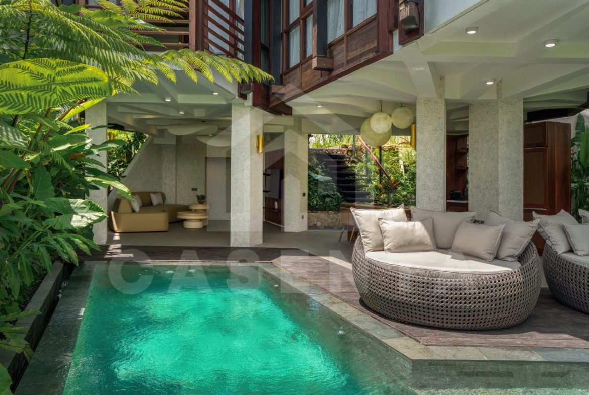 private pool Ubud villa surrounded by tropical plants and lounge area