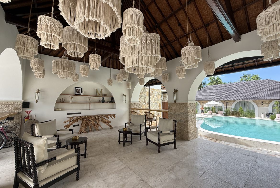 Covered lounge area overlooking pool at Sanur villa
