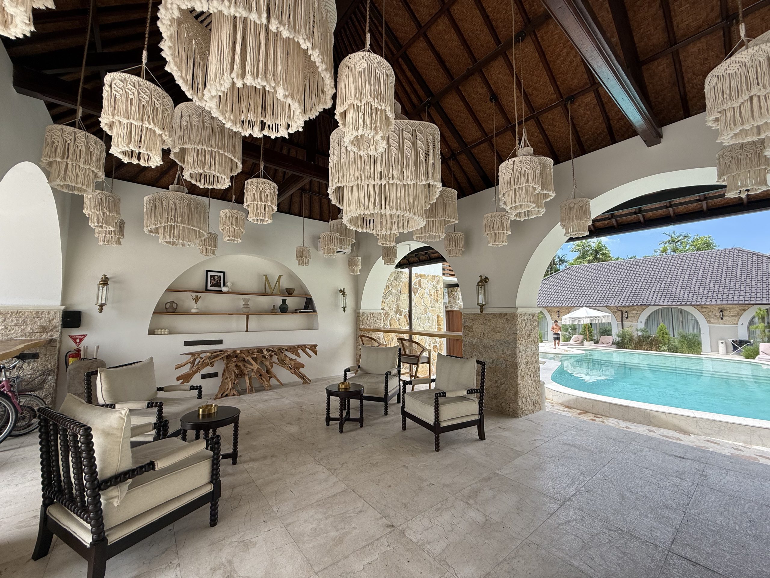 Covered lounge area overlooking pool at Sanur villa