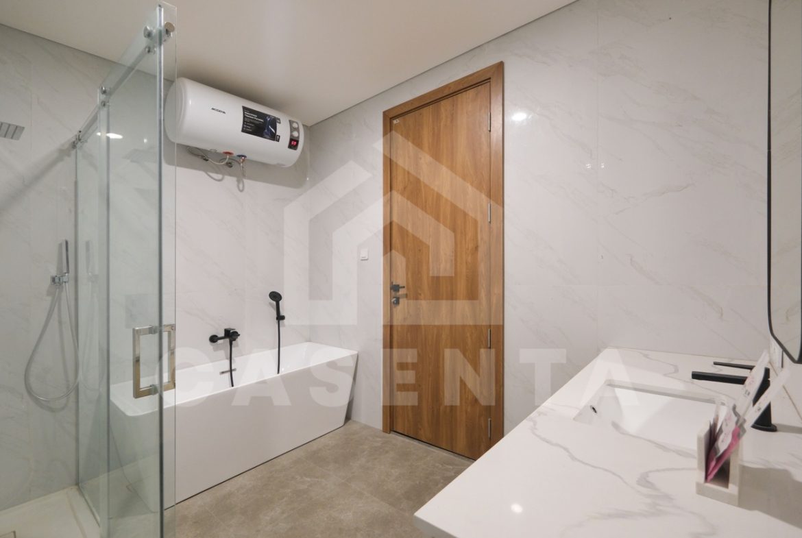 Modern bathroom in Pererenan villa with bathtub and glass shower