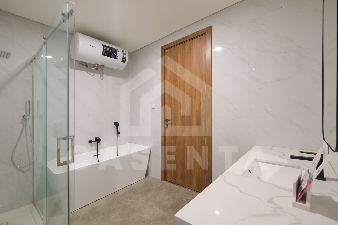 Modern bathroom in Pererenan villa with bathtub and glass shower