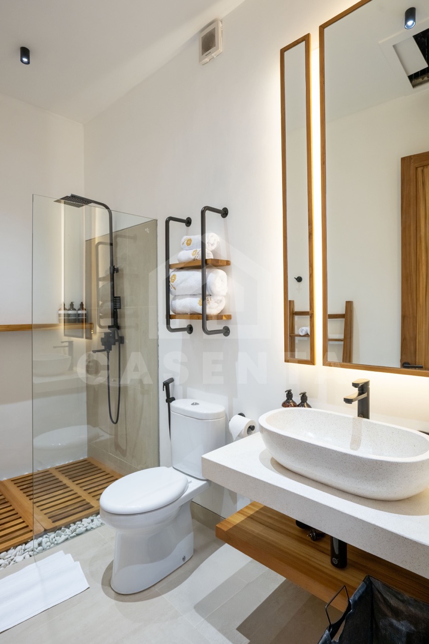 Modern bathroom in Sayan villa with walk-in shower and stone sink