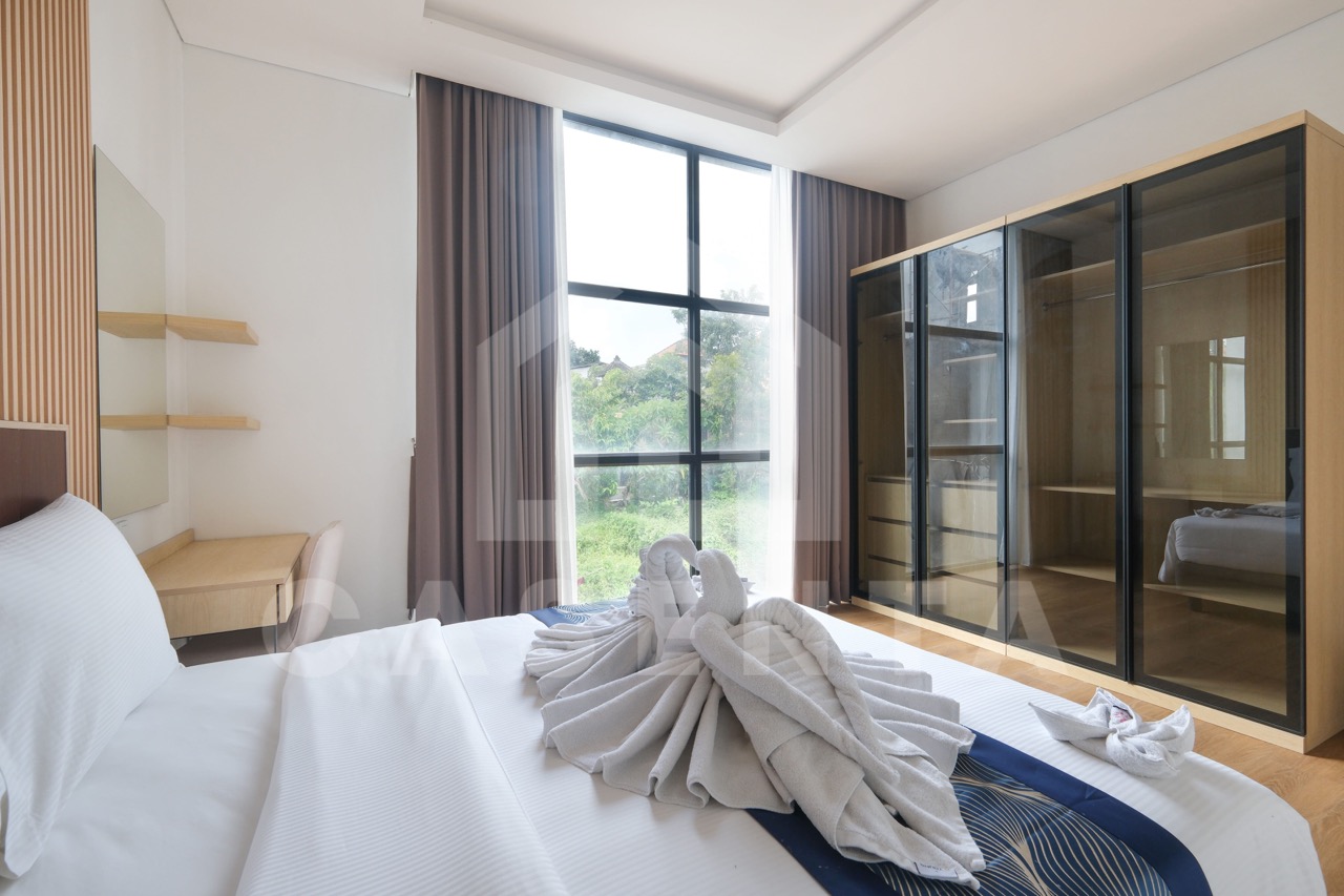 Stylish bedroom with built-in wardrobe in Pererenan villa
