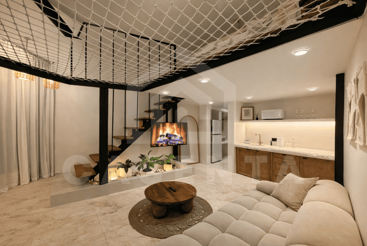 Living and dining area with mezzanine net hammock in Sanur apartment