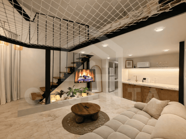Living and dining area with mezzanine net hammock in Sanur apartment