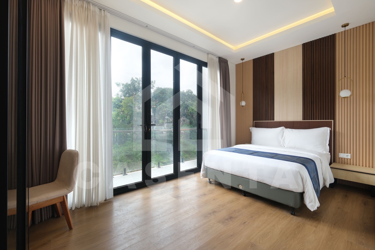Bedroom with large windows in Pererenan villa