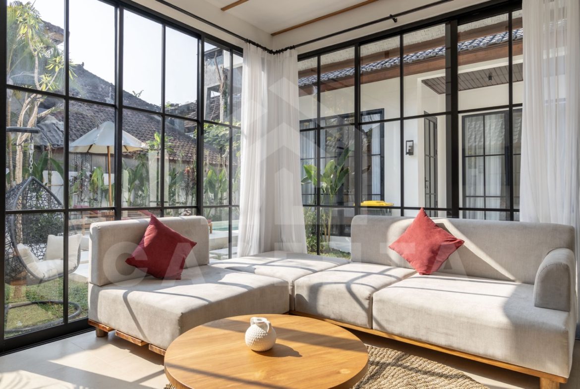 Bright living area in Sayan villa with garden and pool views