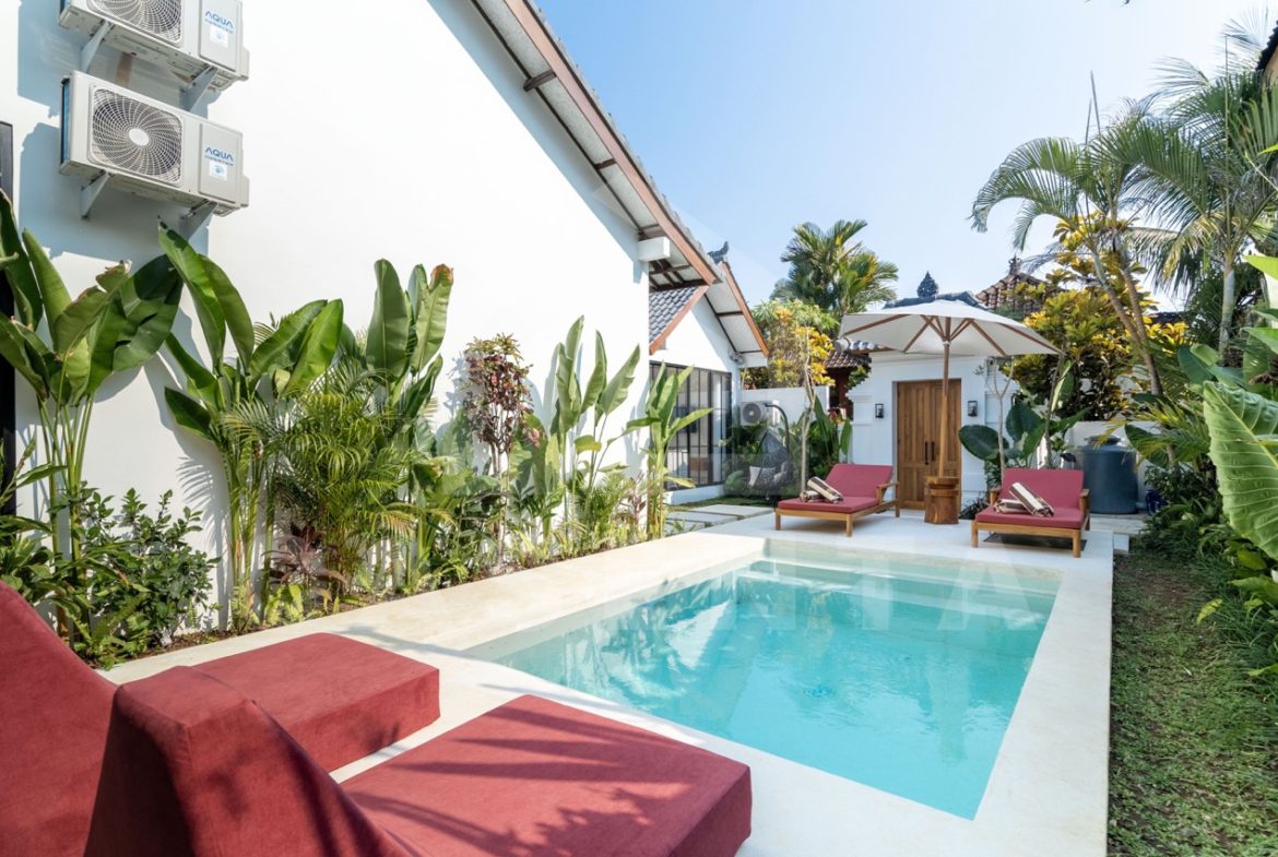 Private pool area in Sayan villa with sun loungers and garden