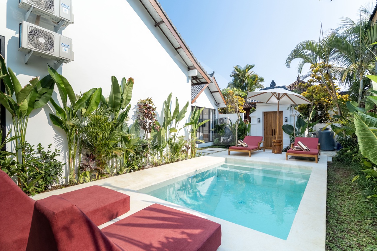 Private pool area in Sayan villa with sun loungers and garden