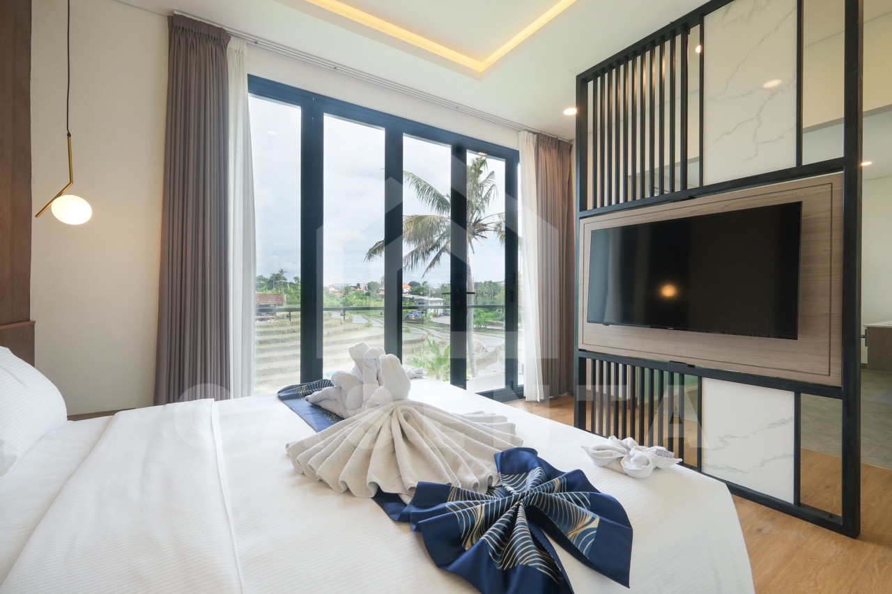 Bedroom with balcony and TV wall in Pererenan villa