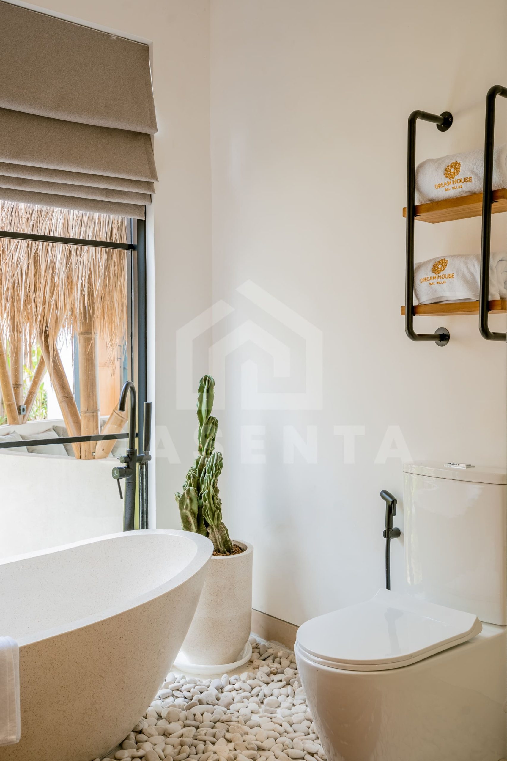 Tropical bathroom with bathtub and natural stone details in Ubud villa