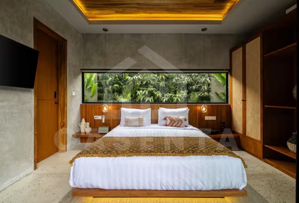 bright bedroom in Bukit villa with large windows and natural light