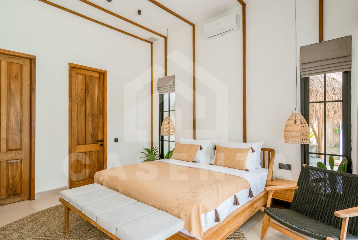 Cozy ensuite bedroom with natural wood design in Ubud villa