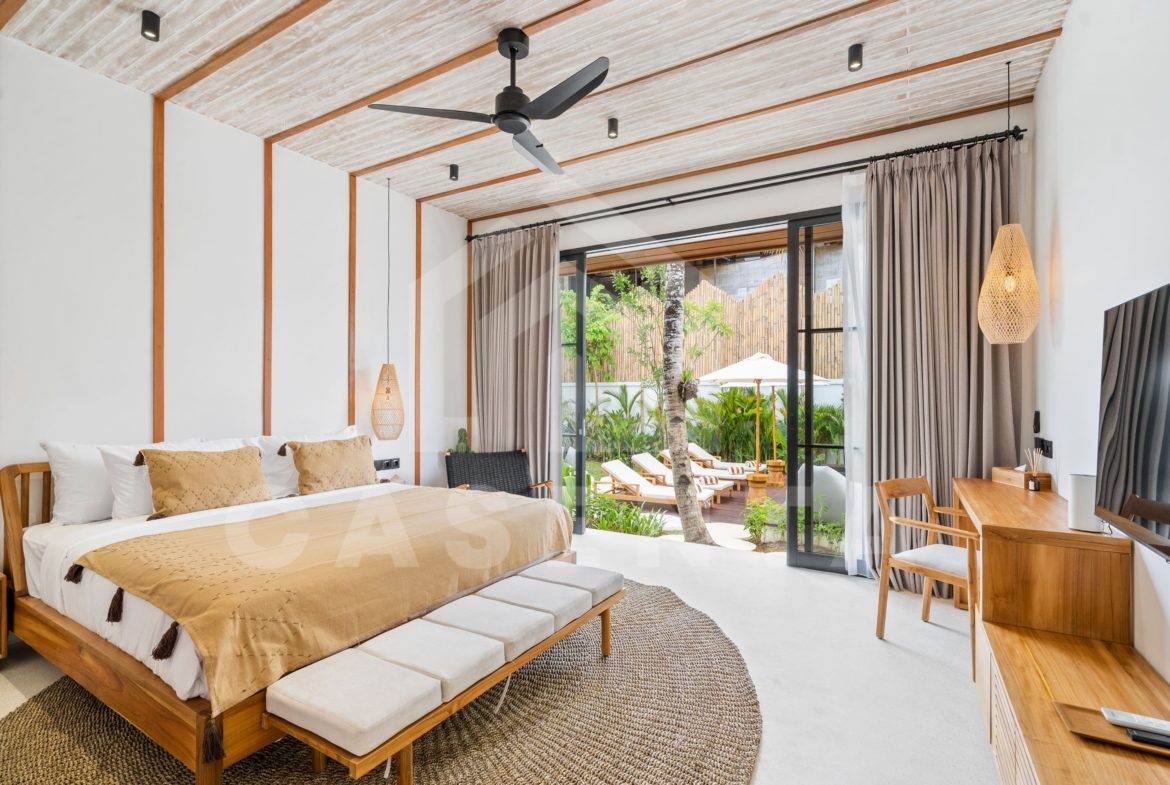 Sayan villa bedroom with garden view and large glass doors