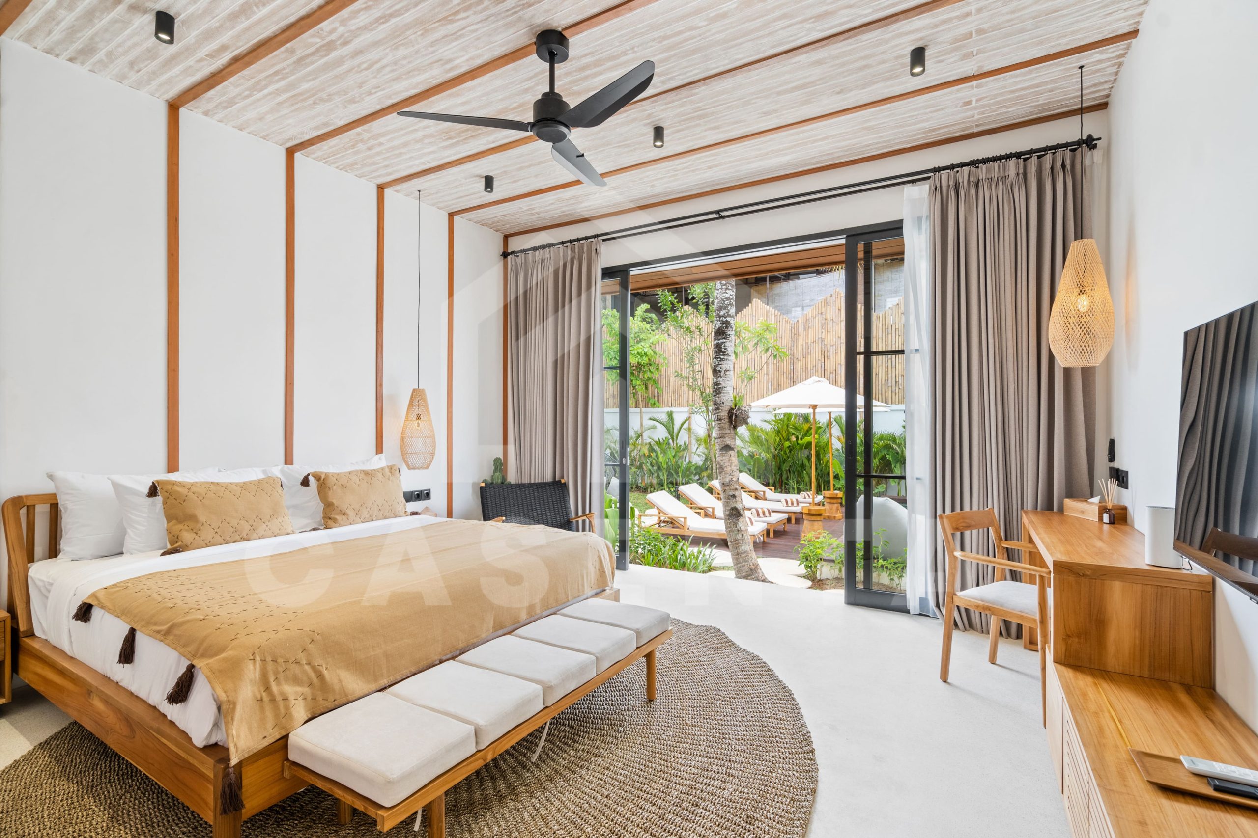 Sayan villa bedroom with garden view and large glass doors