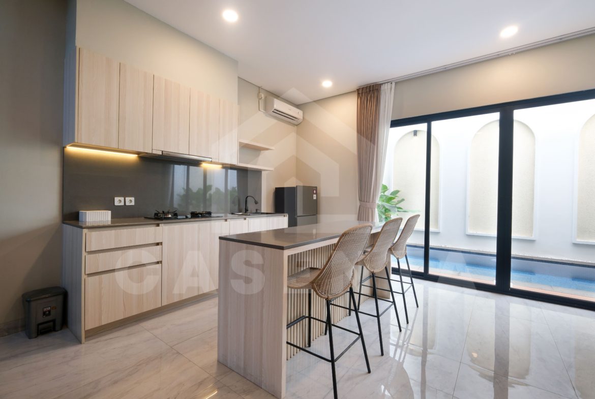 modern kitchen and dining area in Pererenan villa with island