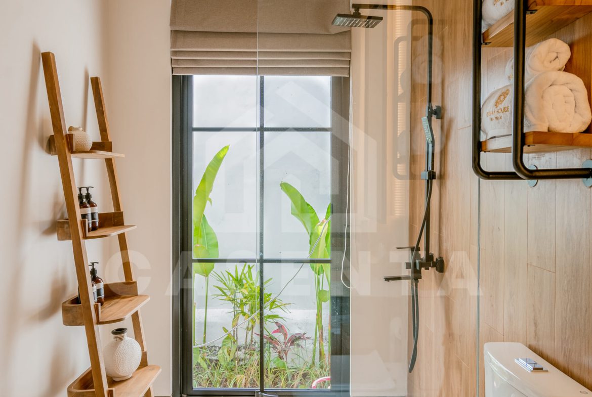 Modern bathroom with shower and natural light in Ubud villa