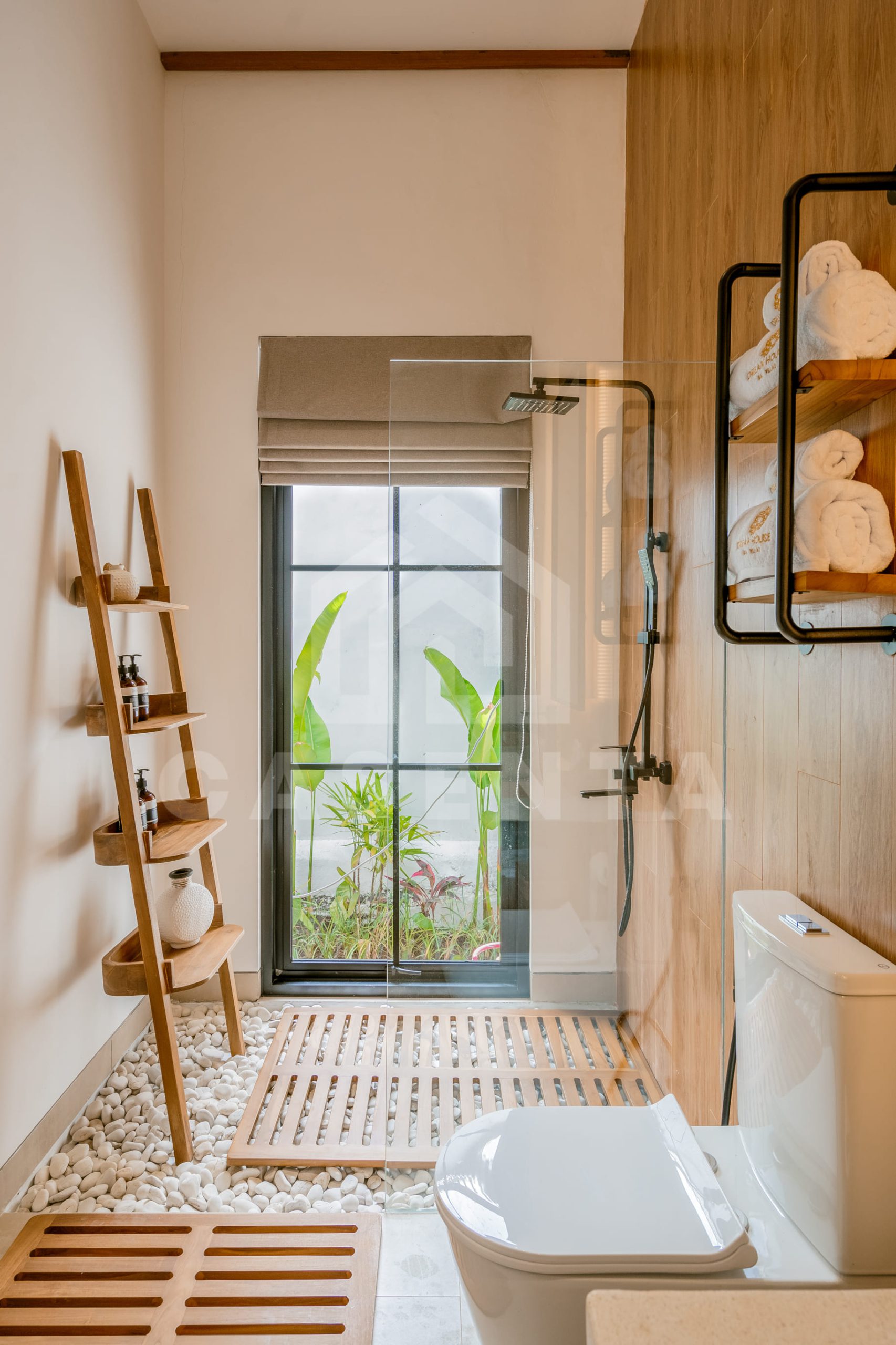 Modern bathroom with shower and natural light in Ubud villa